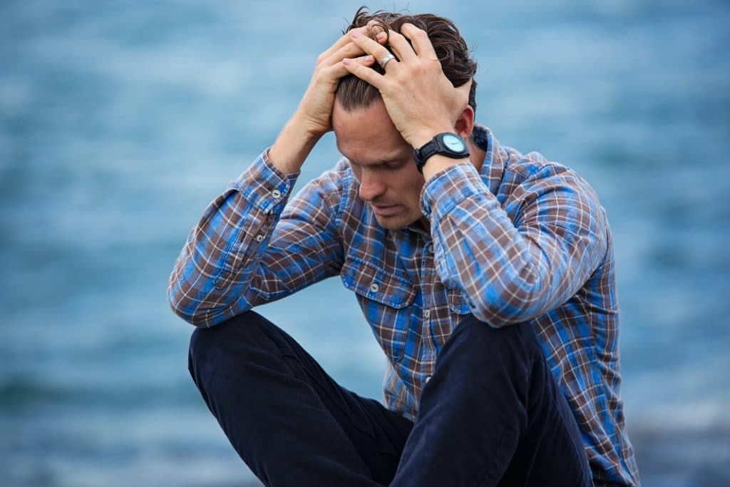 Man With Hands on His Head Dealing with Addiction During COVID-19